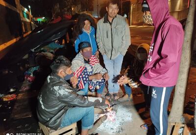 Las personas se arriman al fuego para tratar de agarrar tomar un poco de calor en medio del intenso frío de la noche.