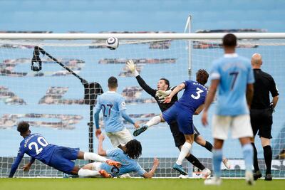 Chelsea's Spanish defender Marcos Alonso (C) shoots over Manchester City's Brazilian goalkeeper Ederson  to score their late winner during the English Premier League football match between Manchester City and Chelsea at the Etihad Stadium in Manchester, north west England, on May 8, 2021. - Chelsea won the game 2-1. (Photo by Martin Rickett / POOL / AFP) / RESTRICTED TO EDITORIAL USE. No use with unauthorized audio, video, data, fixture lists, club/league logos or 'live' services. Online in-match use limited to 120 images. An additional 40 images may be used in extra time. No video emulation. Social media in-match use limited to 120 images. An additional 40 images may be used in extra time. No use in betting publications, games or single club/league/player publications. / 