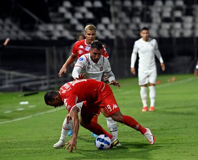 El zaguero central Sergio Vergara intenta proteger el balón ante la marca de Damián Batallini.