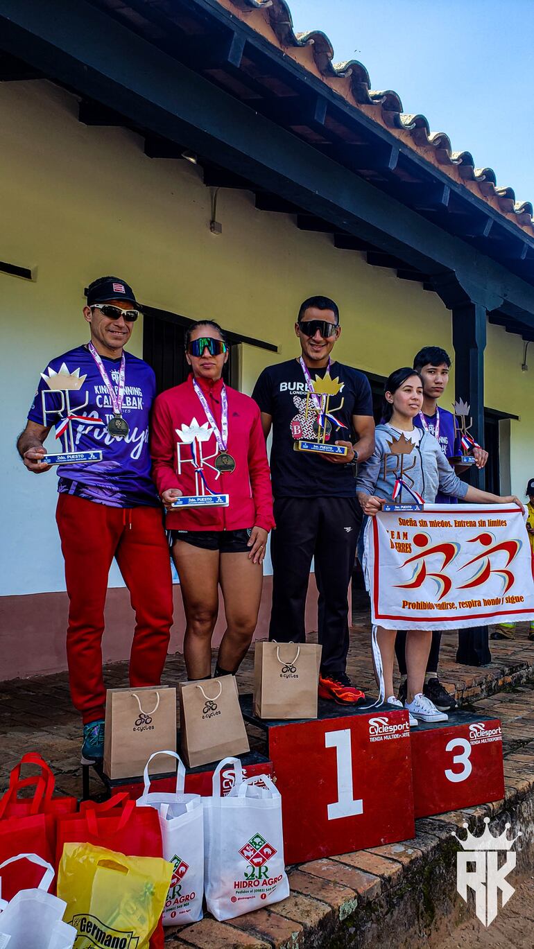 Atletas victoriosos de los 7K festejan al subir al podio.