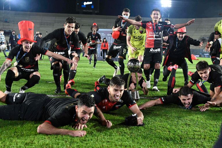 Colon's players celebrate with the trophy of Argentina's Professional Football League tournament, after defeating Racing at the Bicentenario stadium in San Juan, Argentina, on June 4, 2021. (Photo by Andres Larrovere / AFP)